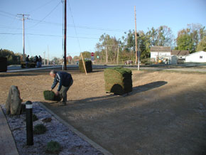 Laying sod behind the monument